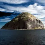 Ailsa Craig is the distinctive dome- shaped island-rock, which rises sharply from the Firth of Clyde.